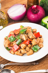 A plate of fried chicken breast with colored pepper