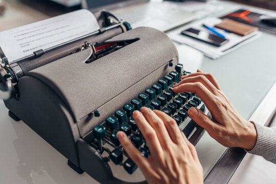 Women's Hands Typing On An Old Typewriter