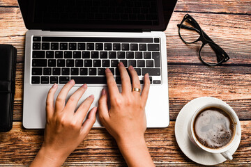 Top view businesswoman typing on laptop at workplace. Woman working in home office hand keyboard. Workplace concept
