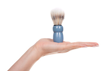 Hand with blue shaving brush, isolated on white background.