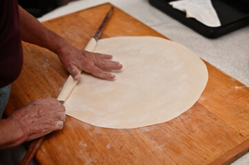 close up of a person preparing a dough