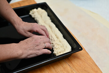 person preparing dough for baking