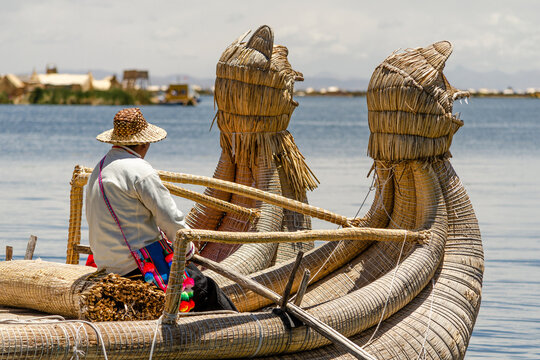 Uro Men Sailing On A Totora Boat At Titikaka Lake