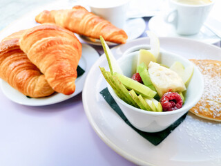 Breakfast with orange juice and fresh fruits on table