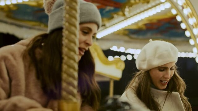 Video of crazy friends  having fun on carousel  in funfair. Shot with RED helium camera in 8K.  
