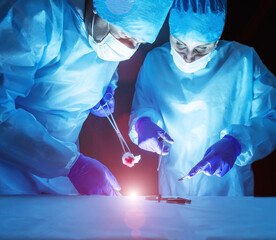 Two doctors perform laser surgery to treat varicose veins and hemorrhoids. Concept laser surgery