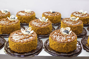 A lot of chocolate sponge cakes with condensed milk and prunes in the confectionery industry, making. Food industry, torte