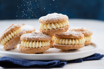 Delicious hazelnut shortbread sandwiches filled with vanila cream. Christmas recipe.