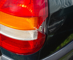 damage to the taillight of the car, accident. Car insurance, background, close-up © HENADZY
