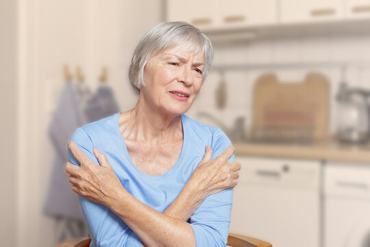 Polymyalgia rheumatica: old woman suffering from acute pain in her upper arms, filter effect.