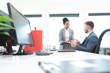 Businesswoman & coworker in discussion