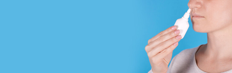 Girl using nasal spray with hand, copy space template, banner.