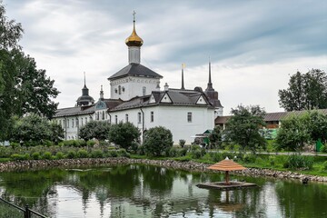 Russia, Yaroslavl, July 2020. View of the courtyard of an Orthodox monastery with a pond and swans.
