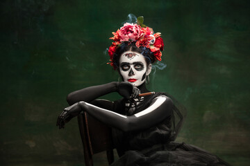 Smoke. Young girl like Santa Muerte Saint death or Sugar skull with bright make-up. Portrait...