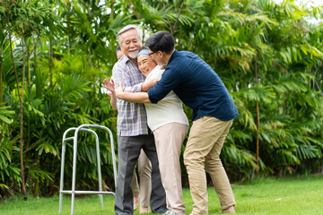 Asian family with love. 4 People. happy family shows love by hugging each other on the lawn at home.