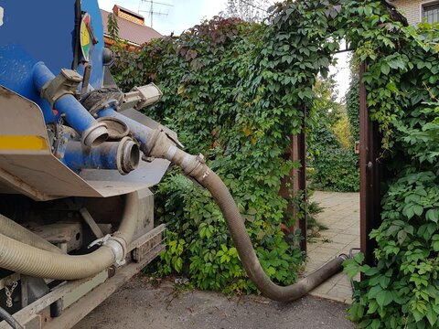 Image of units of a pumping machine for pumping out a septic tank. Sewerage in a private house.