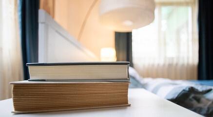 books on bedroom table by bed