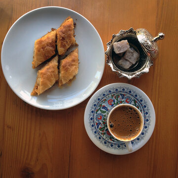 A cup of Turkish coffee and baklava with loukum.