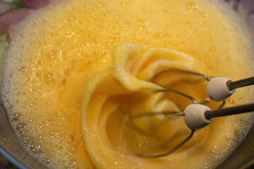 Beating the dough with the whisk of a mixer - cooking at home