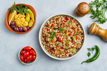 Bulgur pilaf with eggplant and vegetables. Top view with copy space