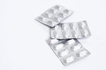 Capsule pills medicine in silver aluminium blister pack on white background. Copy space. Top view. Flat lay. Isolated. Concept pharmacy, medicine, healthcare, painkillers, drug, abuse