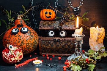 Halloween pumpkin on a pile of books next to a burning candle