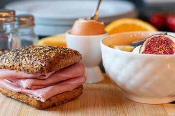 Healthy breakfast sandwich with fruit salad and egg