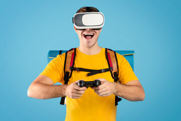 Virtual tourism. Excited guy with VR headset and controller watching travel tour in cyberspace on blue background