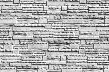 Naklejki  Czarno-biała faktura ściany pokrytej dekoracyjnymi płytkami ceglastymi. Streszczenie tło dla projektu.