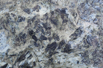 Rough abstract textured surface of gray and blue stone. Cracked stone background