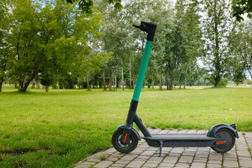 electric scooter - modern eco friendly public and private everyday transport parked on nature background ready for rent and online booking on app