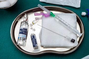 Vials with lidocaine anesthesia prepared for operation in an operating room, conceptual image