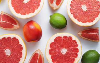Fresh fruit mix on a white background. Grapefruit, lime, nectarine. Top view. Sliced