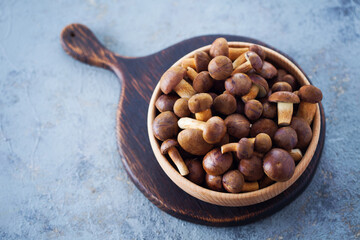 wooden bowl full of fresh mushrooms