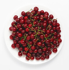 Fresh cherries on a plate. White background