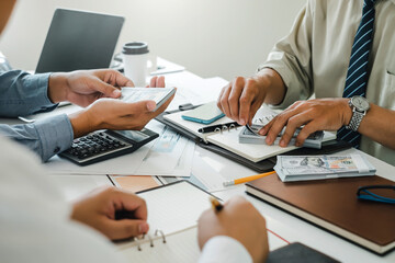 Group of business people brainstorming, analyzing and planning working together at the meeting.