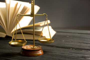 Law concept - Open law book with a wooden judges gavel on table in a courtroom or law enforcement office isolated on white background. Copy space for text