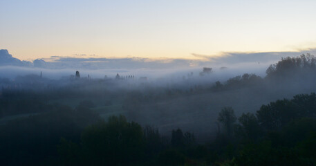 village in the fog in Tuscany