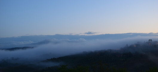 Fototapeta premium village in the fog in Tuscany