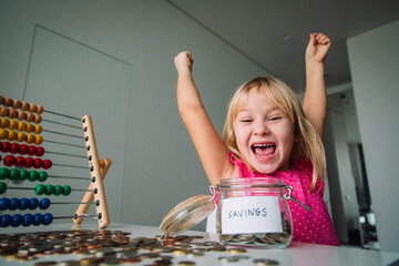 happy cute girl saving money, kid counting coins