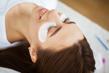 Eyelash Extension Procedure, Professional stylist lengthening female lashes.