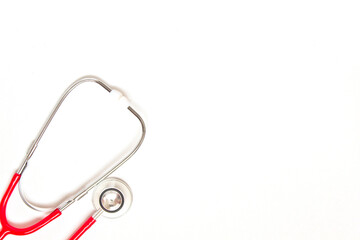 Medical red stethoscope on white background. Copy space.