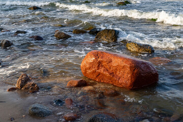 Large stone on the rocky beach of the sea. Baltic sea coast.