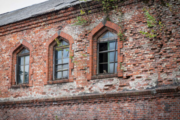 An old abandoned building. Collapsing walls and windows. Deserted and forgotten house. Former defensive building.