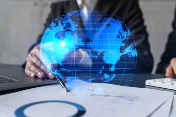 Man and woman working together on international business project. Blue infographic hologram of planet earth. World map. Multiexposure. © VideoFlow