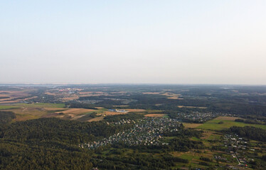 Beautiful top view of the forest and suburb with houses and a park