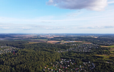 Beautiful top view of the forest and suburb with houses and a park