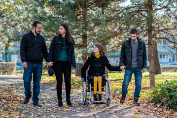 Young disabled woman with friends in a park