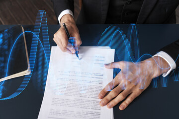 Businessman in suit signs contract. Double exposure with financial chart hologram. Man signing...
