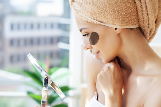 Portrait Of Beauty Woman With Eye Patches Showing An Effect Of Perfect Skin.